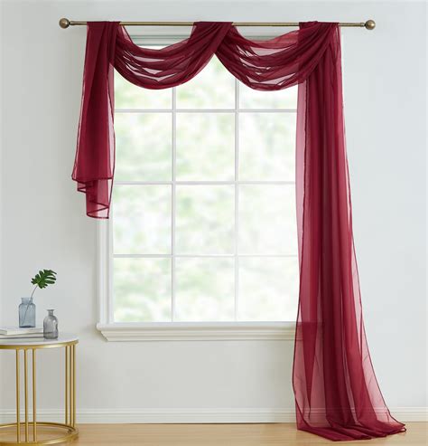 Loop the fabric hanging on the back over the right side of the pole. . Window curtain scarves